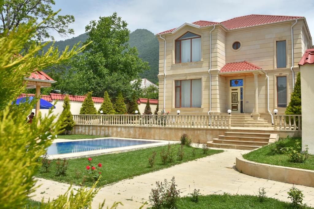 a house with a swimming pool in a yard at Foothills Villa in Gabala