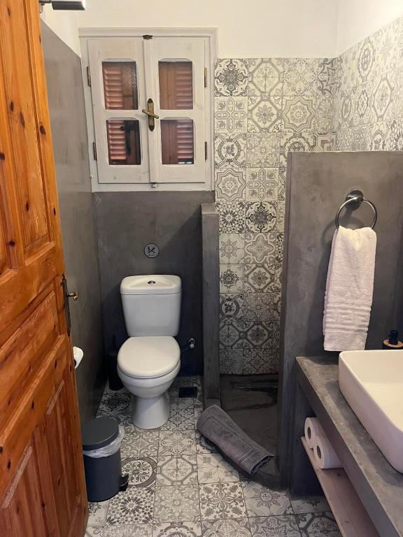 a bathroom with a toilet and a sink at Panorama Thea in Symi