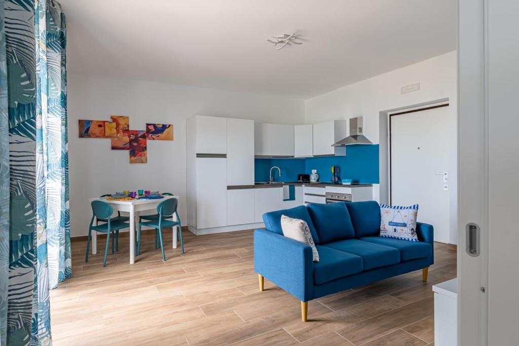 Il comprend un salon avec un canapé bleu et une cuisine. dans l'établissement Maranto Vista - YourPlace Abruzzo, à Fossacesia