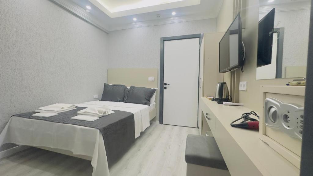 a hotel room with a bed and a television at La Mer Old City Hotel in Istanbul