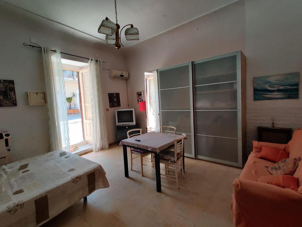 a living room with a table and a couch at Domus Aurea da Carlo in Ravanusa