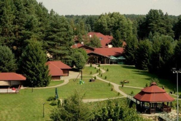 an aerial view of a park with buildings and trees at Bobrowy Resort in Zabłudów