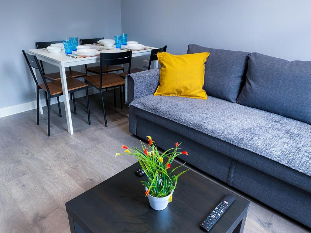 a living room with a couch and a table at Stylish 1 Bedroom Flat in wood Green in London