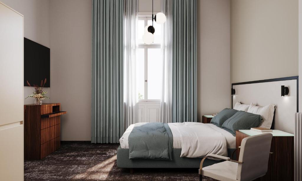 a bedroom with a bed and a television and a chair at Esplanade Carlsbad in Karlovy Vary