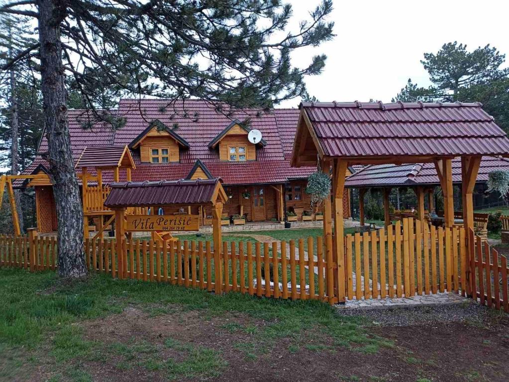 a wooden fence in front of a house at Vila Perisic in Kaludjerske Bare