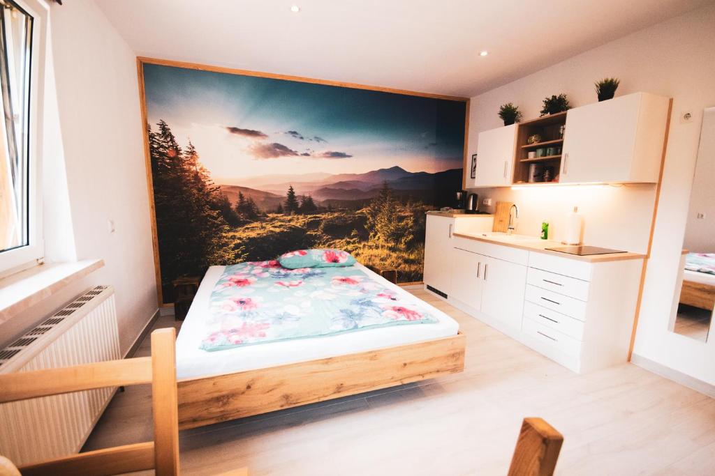 a bedroom with a large painting on the wall at Northwest Studio Apartments in Klagenfurt