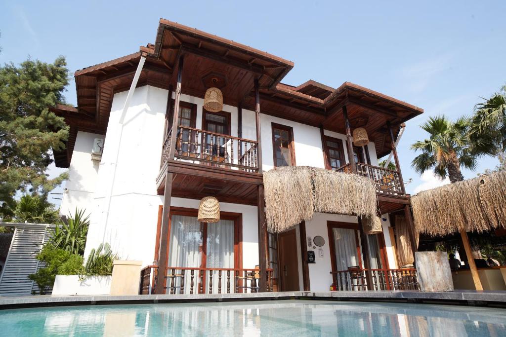 a house with a swimming pool in front of a house at No 22 Riders' Inn in Akyaka