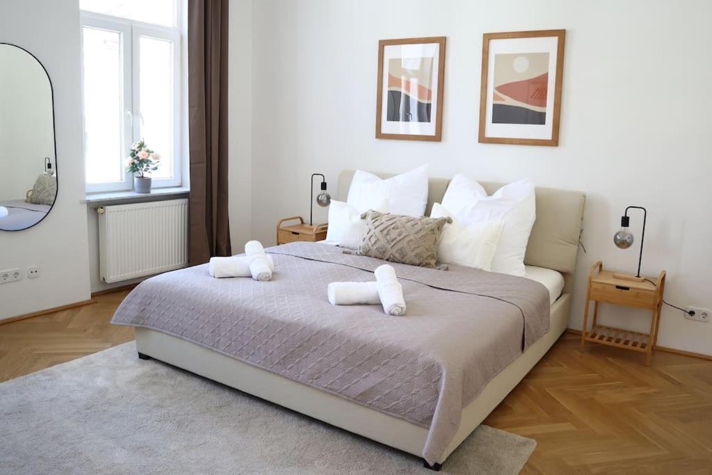 a bedroom with a large bed with two towels on it at BLOOM - Cozy Apartment, 5 stops to City Center in Vienna