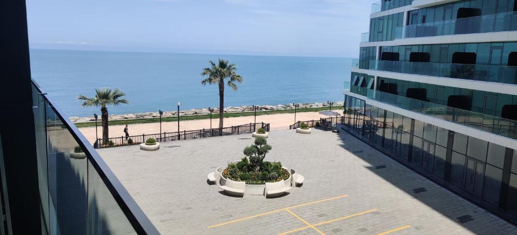 a balcony of a building next to the ocean at Batumi Sea View in Batumi