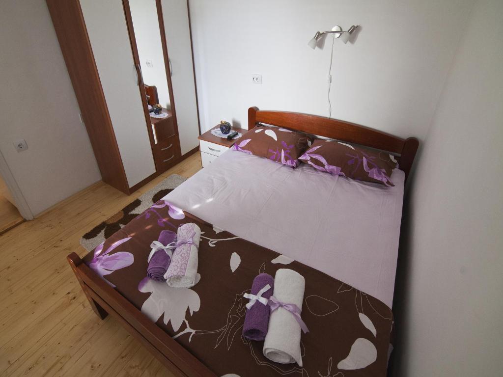 a bedroom with a bed with shoes on it at Apartment Manuela in Dubrovnik