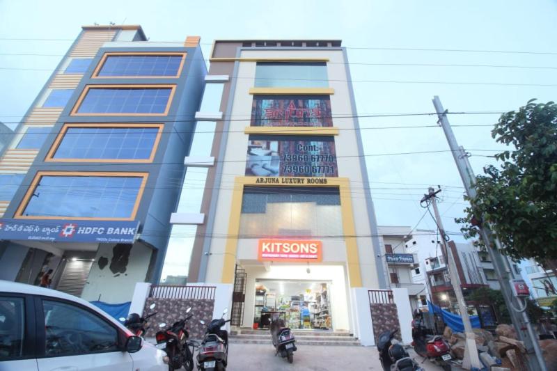 a building with motorcycles parked in front of it at Arjuna Luxury Rooms in Hyderabad