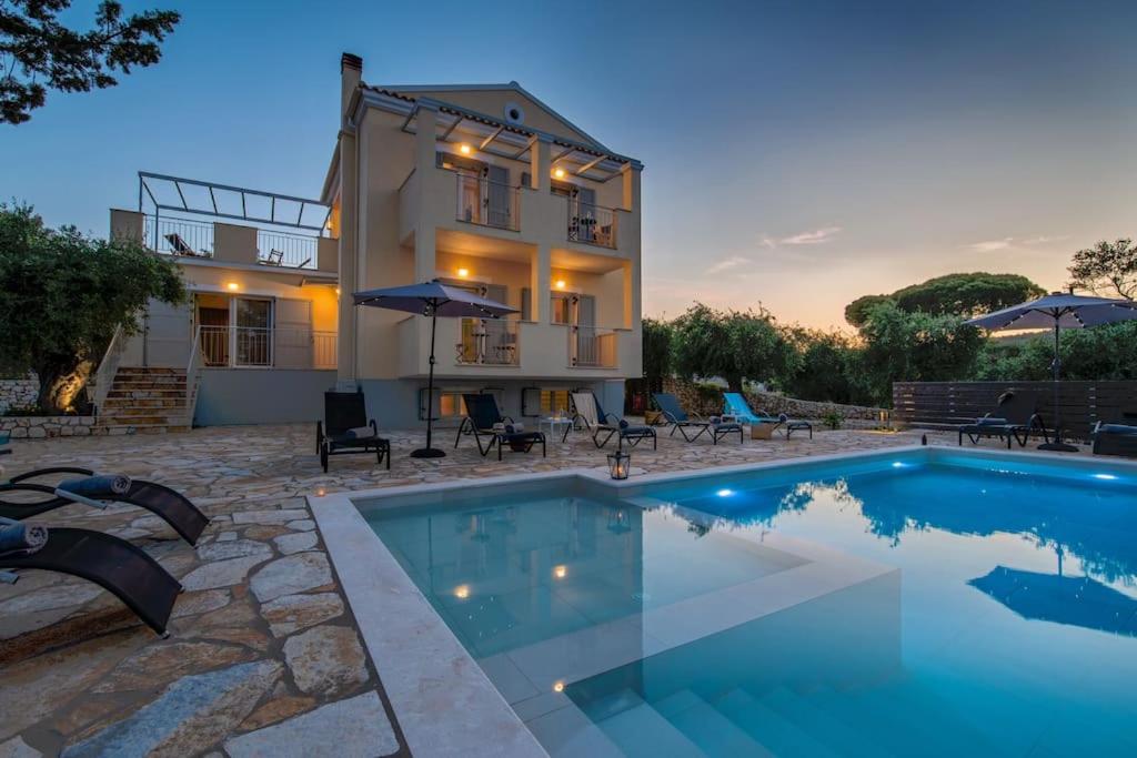 a house with a swimming pool in front of a house at A Casa D' Irene Gaios Paxos in Gaios