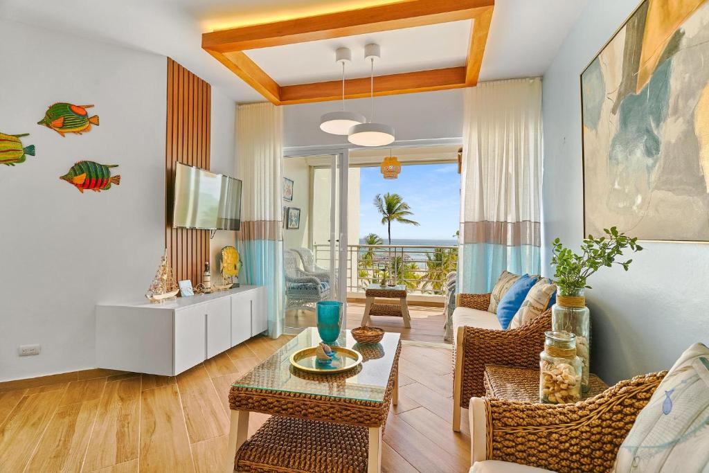 a living room with a couch and a table at New! Unique Beachfront And Pool View Apartment At Juan Dolio in Juan Dolio
