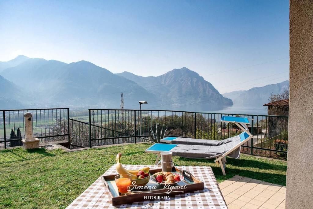 a table with a bowl of fruit on top of a balcony at Il Giardino di Laura in Costa Volpino