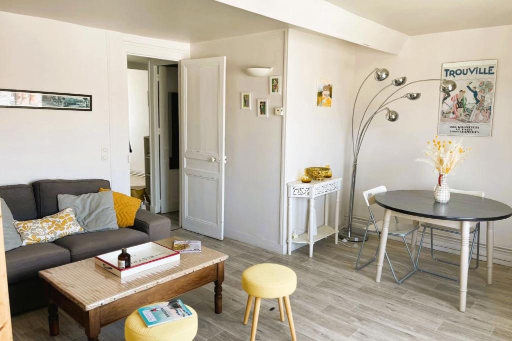 a living room with a couch and a table at luminous apartment in the heart of trouville in Trouville-sur-Mer