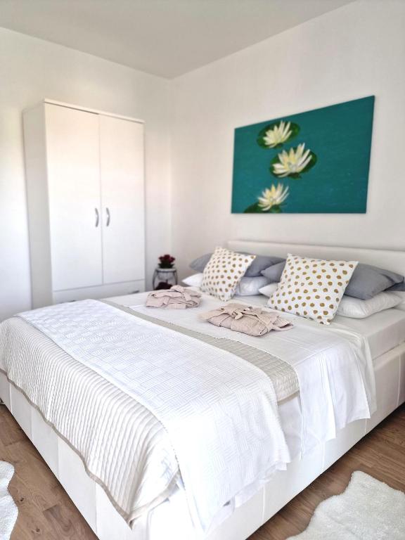 Postel nebo postele na pokoji v ubytování Cappelli Apartments - Lošinj