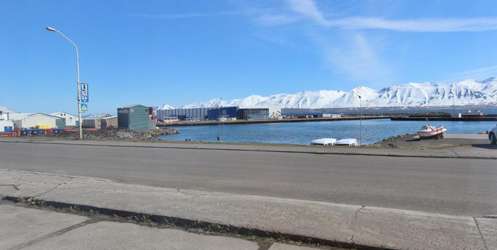 a view of a body of water with snow covered mountains at Beautiful house with amazing sea view. in Dalvík