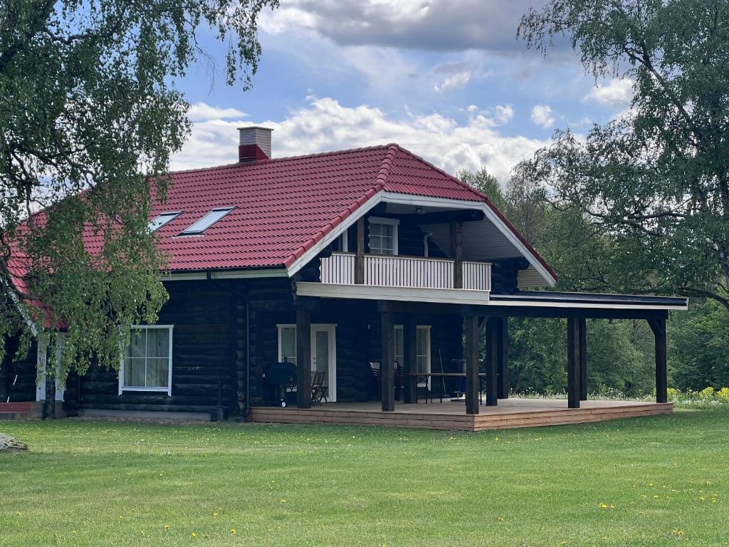 a large house with a porch and a deck at Tuule Countryhouse in Päidla
