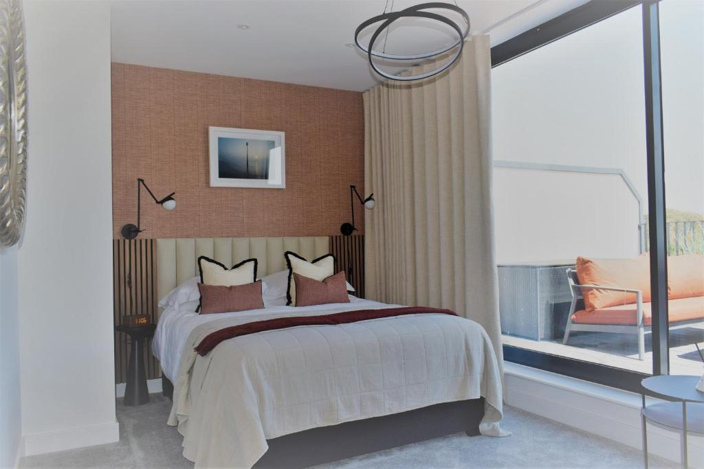 a bedroom with a bed and a large window at 17 The Fairways in Broadstairs