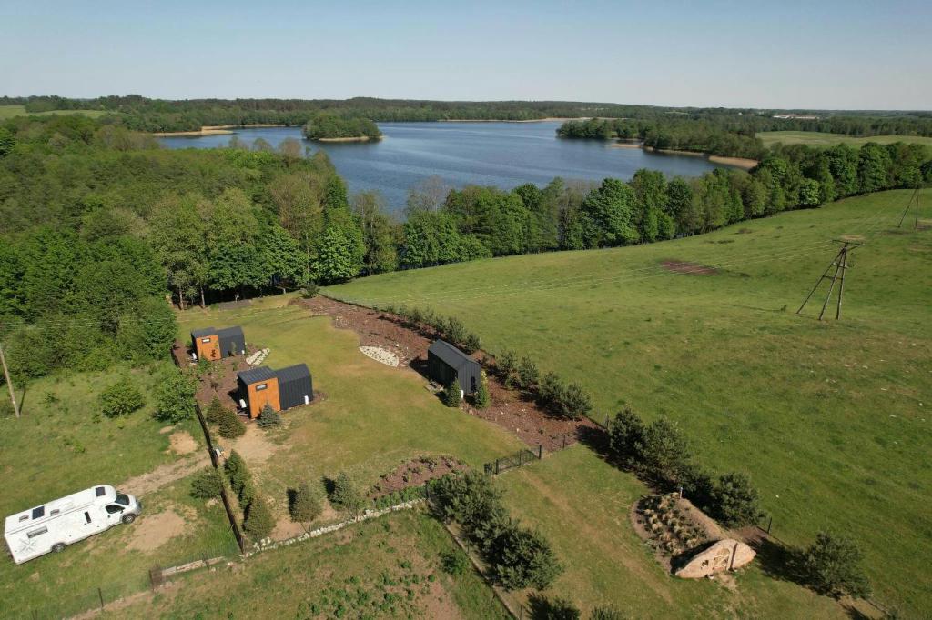 an aerial view of a farm with a rv and a lake at Zielona Górka in Biskupiec