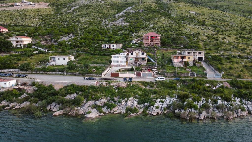 an aerial view of a house on an island in the water at LakeFront House in Shirokë