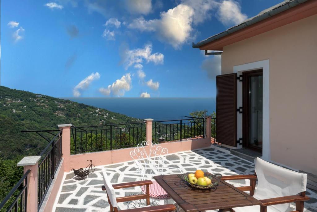 a balcony with a table and chairs and the ocean at Pantheon 2 in Mouresi