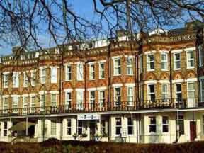 a large brick building with a balcony in front of it at The Bournemouth Maemar Hotel in Bournemouth