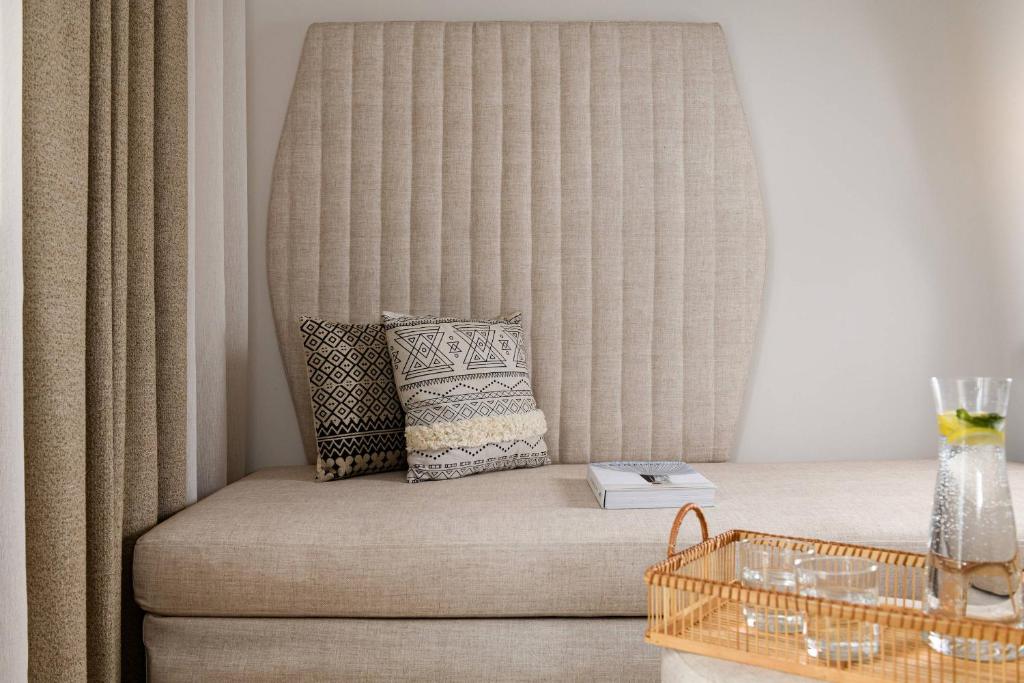 a couch with a pillow on it in a room at Hotel Villa Natassa in Skala Rachoniou