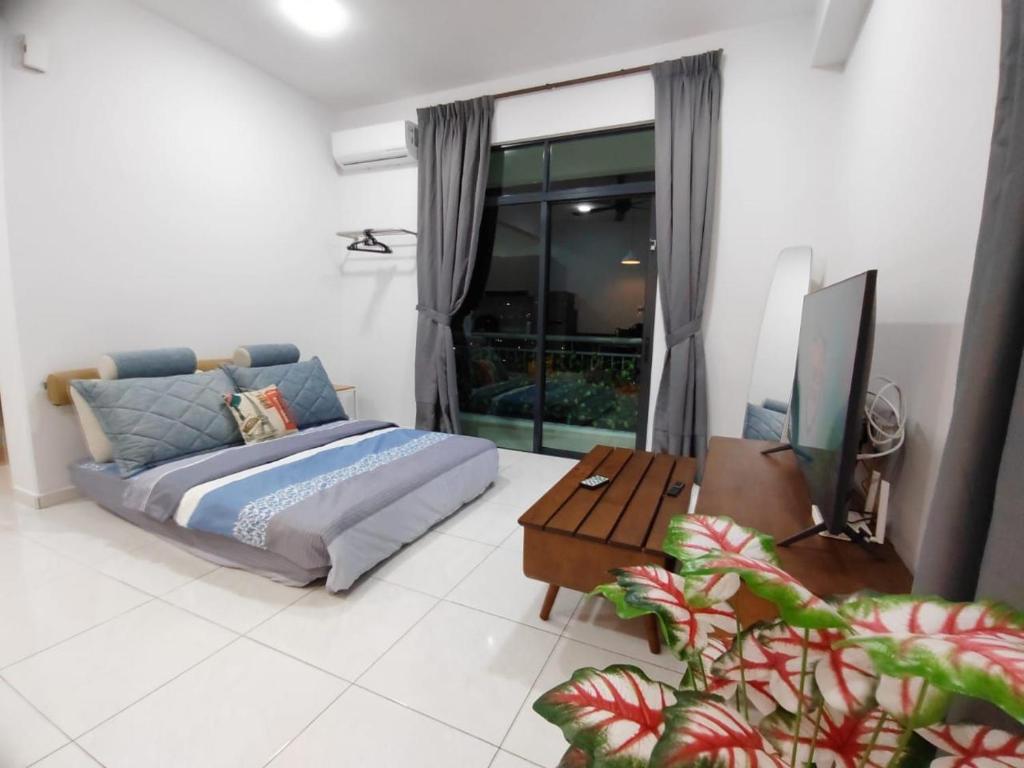 a bedroom with a bed and a table and a couch at New Cozy The Sun Homestay at Sg Nibong Bayan Lepas Factory Area in Bayan Lepas