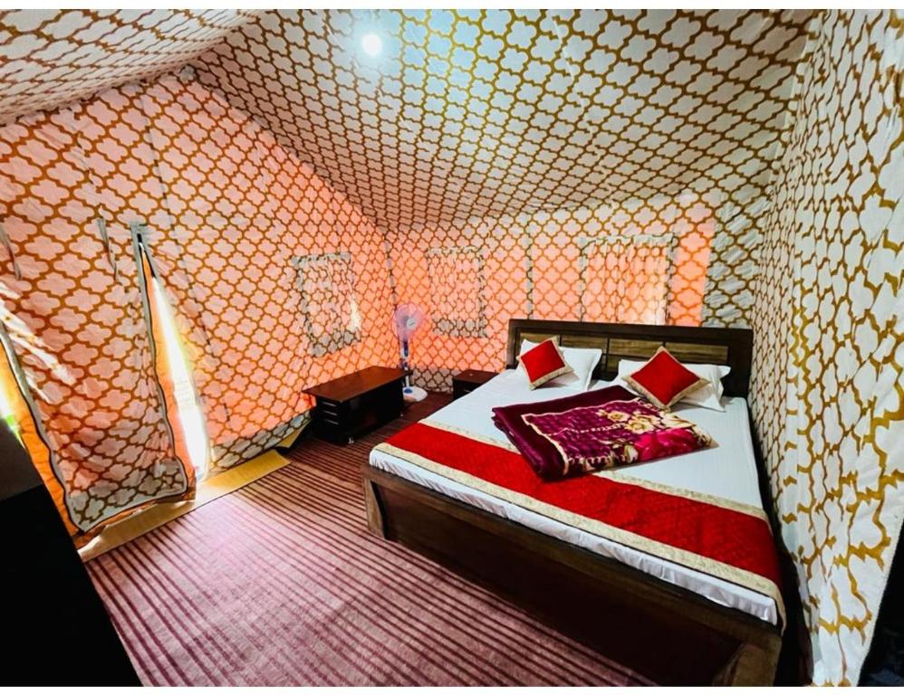 a bedroom with a bed in a room with a wall at Sumeru Camp,Barkot in Barkot