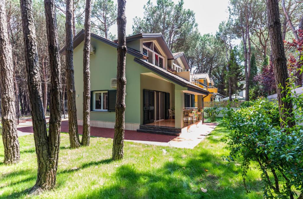 a house in the woods with trees at Forest Cottage - middle of forest & near the beach in Golem