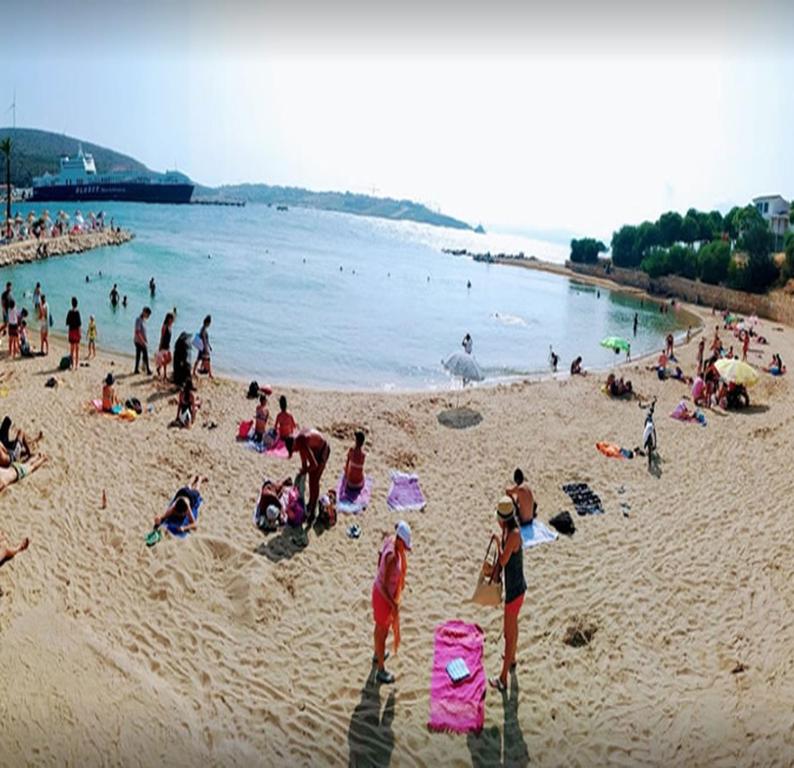 a large group of people on a beach at Grand Faik Hotel in Çeşme