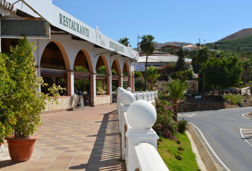 a white fence in front of a building at Habitacion rural en Alora Caminito del Rey in Málaga