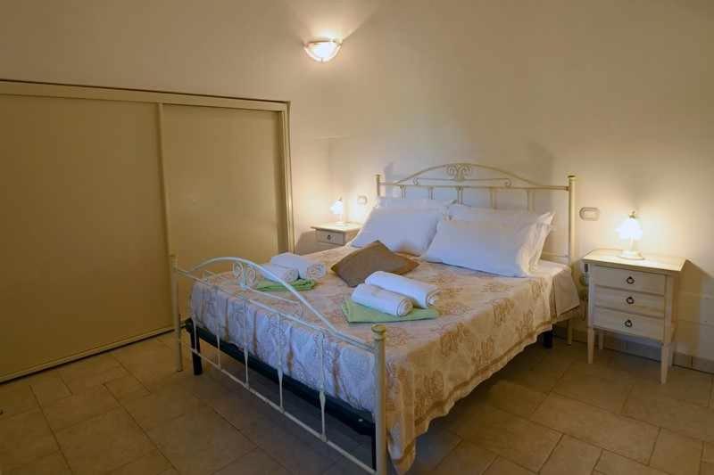 A bed or beds in a room at Trullo Antico with exclusive swimming pool