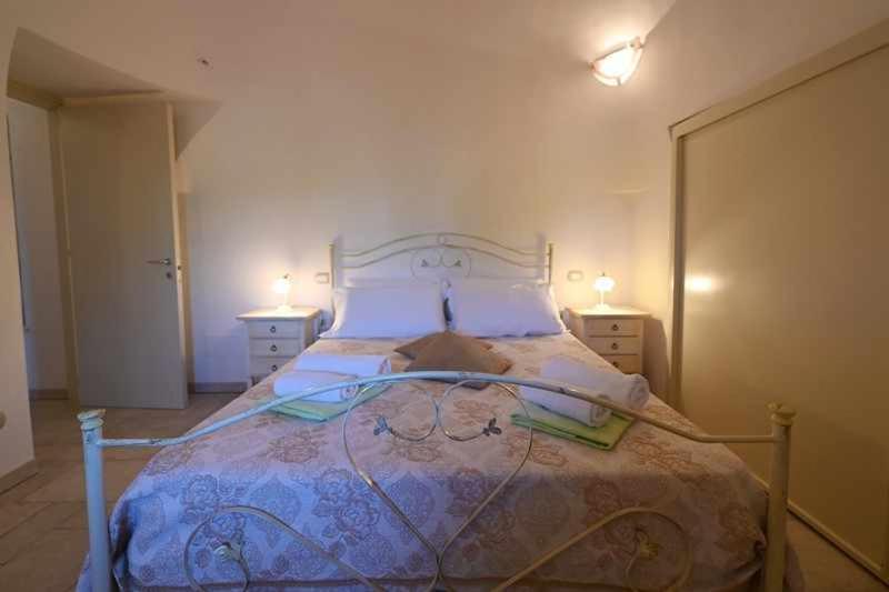 A bed or beds in a room at Trullo Antico with exclusive swimming pool