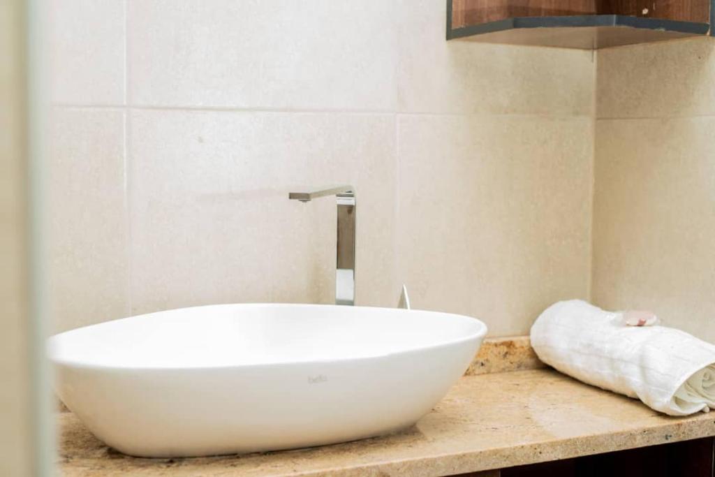 a white bath tub sitting on a counter in a bathroom at Sunnyside Inn in Blantyre