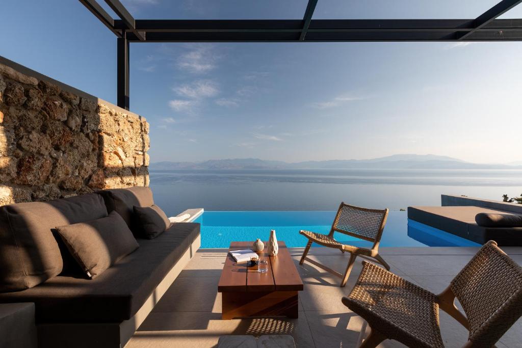 a living room with a view of the water at ​Le Grand Bleu Resort in Derveni