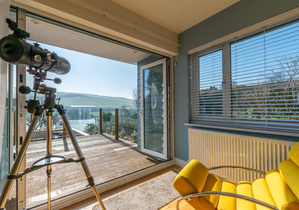 a camera on a tripod in a room with a balcony at Riverside House in South Pool