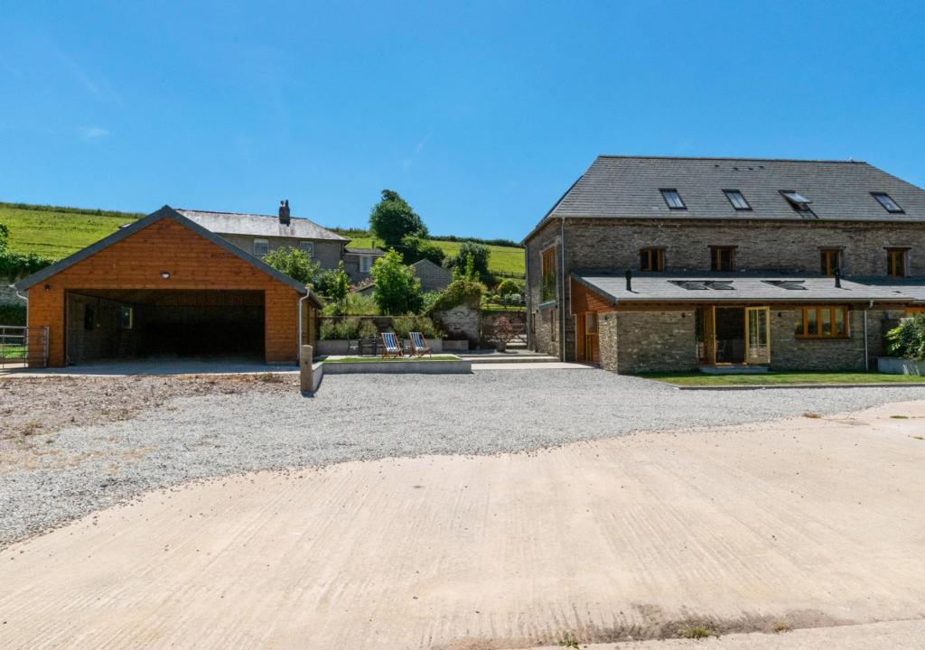 a house with a garage and a barn at The Meadows 