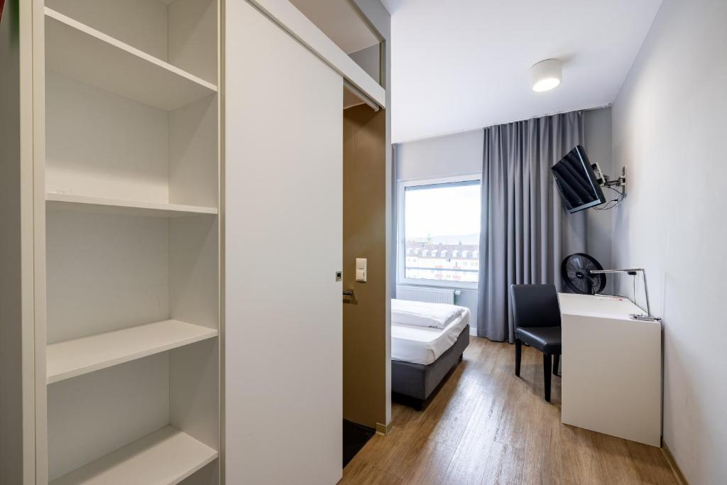 Postel nebo postele na pokoji v ubytování mk hotel stuttgart