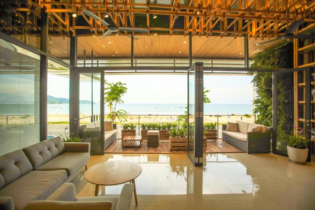 a living room with a view of the ocean at DA NANG BAY HOTEL in Da Nang