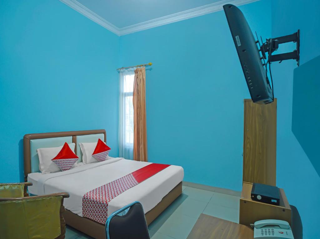 Voodi või voodid majutusasutuse OYO 92577 Hotel Sidikalang toas