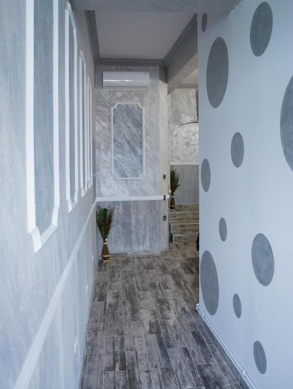 a hallway with a stone wall and a window at LUXURY ERK in Călimăneşti