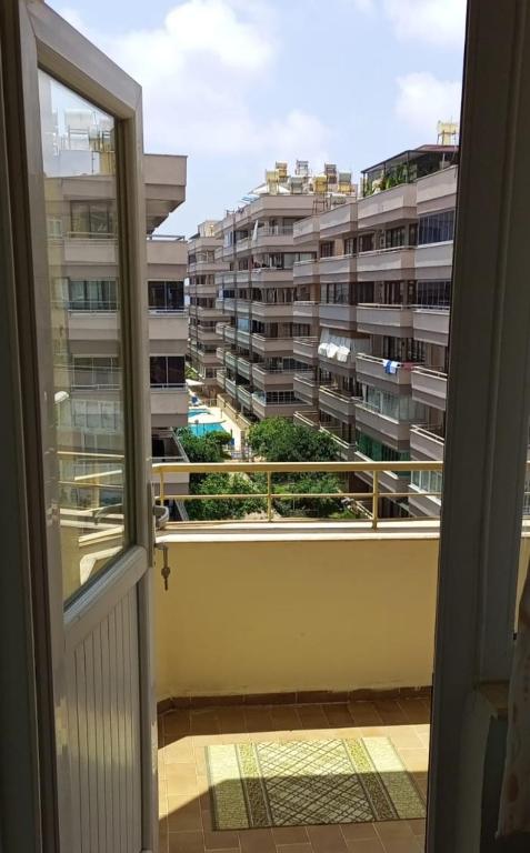 a balcony with a view of a large building at The apartment is not for rent in Mahmutlar