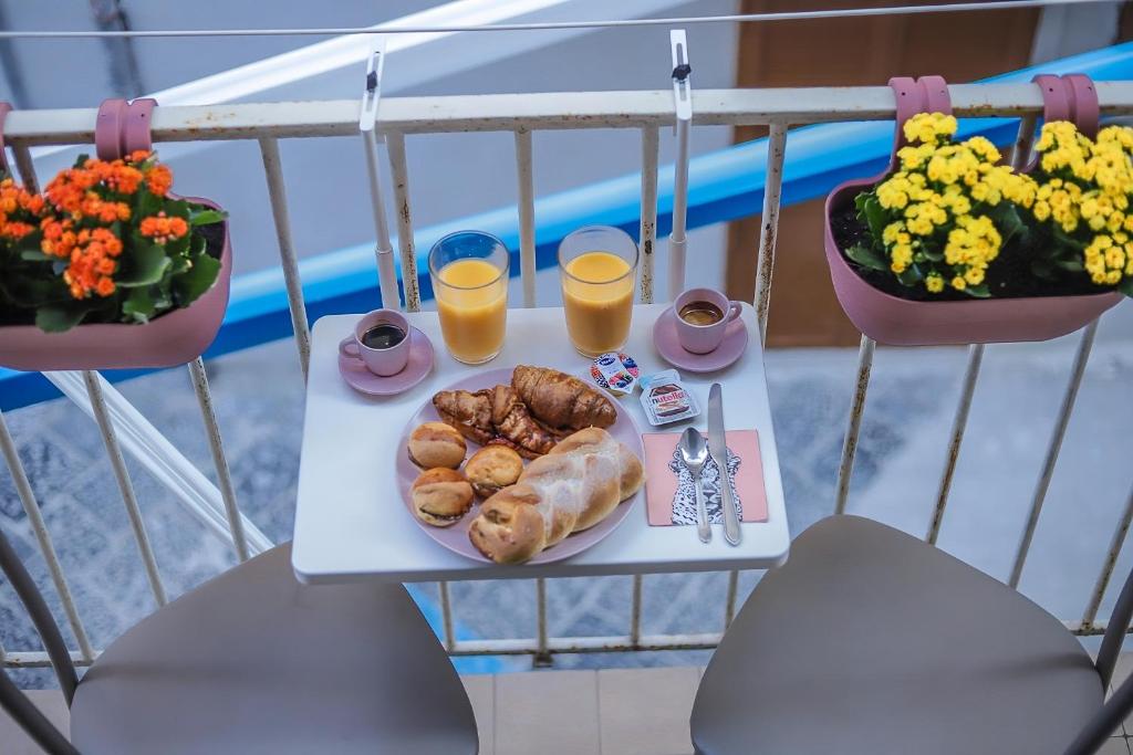 un tavolo con un piatto di cibo e due bicchieri di succo d'arancia di Reginella a Toledo a Napoli