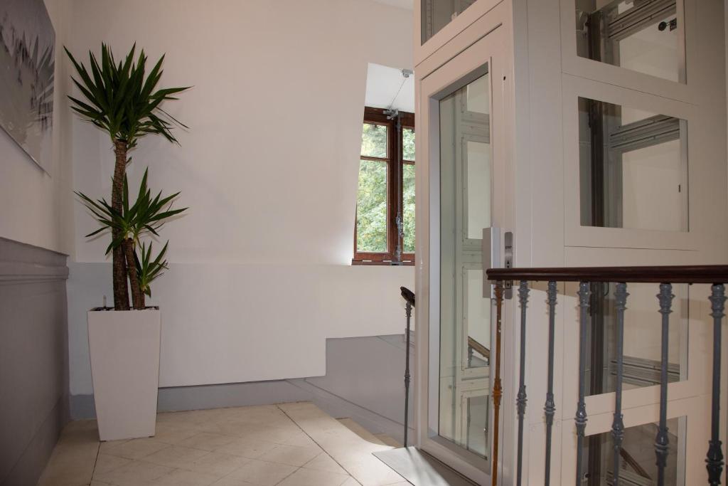 a hallway with a door and a potted plant at Villa Saint Enogat in Aix-les-Bains