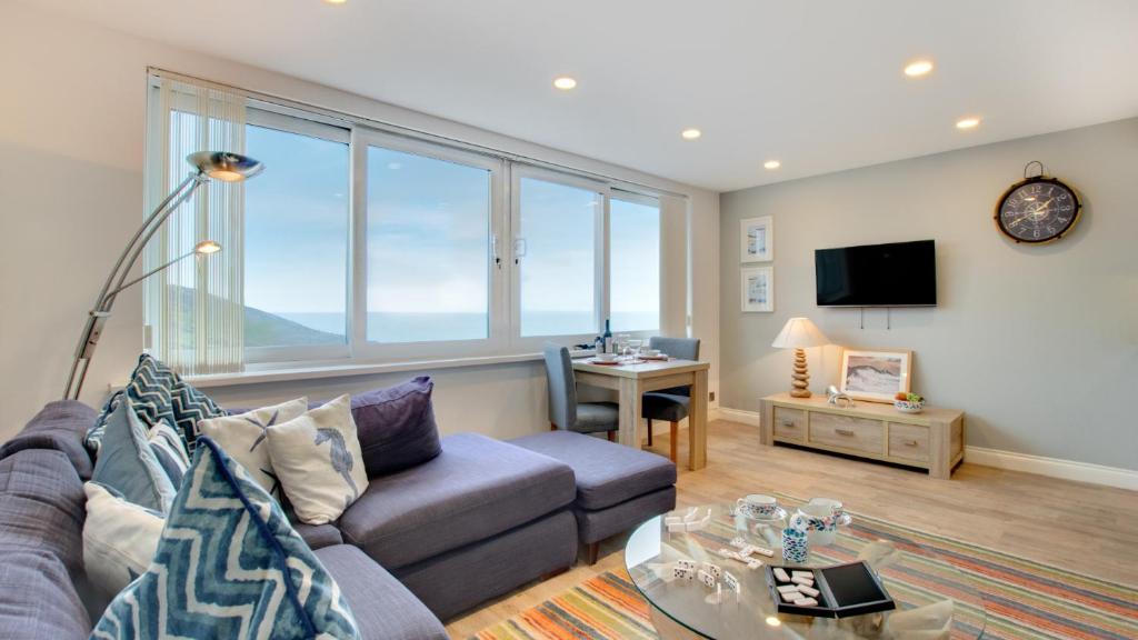 a living room with a couch and a table at Limeslade Court in The Mumbles