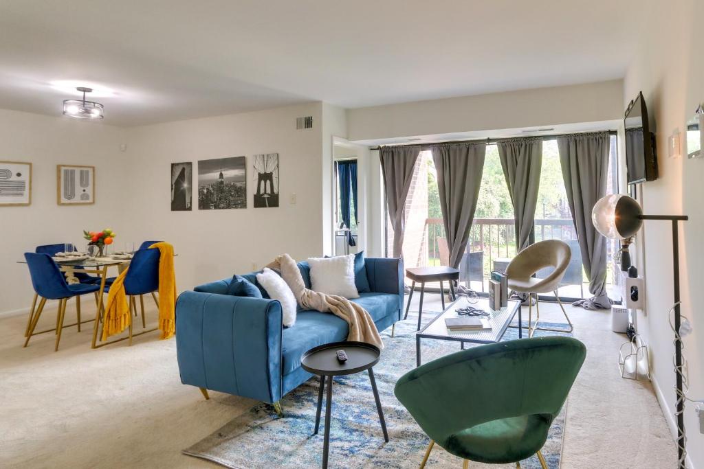 a living room with a blue couch and chairs at Cozy Laurel Condo with Pool Access, about 20 Mi to DC! in Laurel