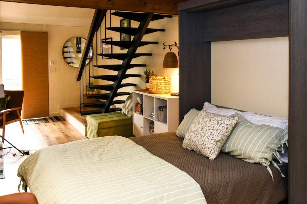 a bedroom with a bed and a spiral staircase at Virgil Mountain View 