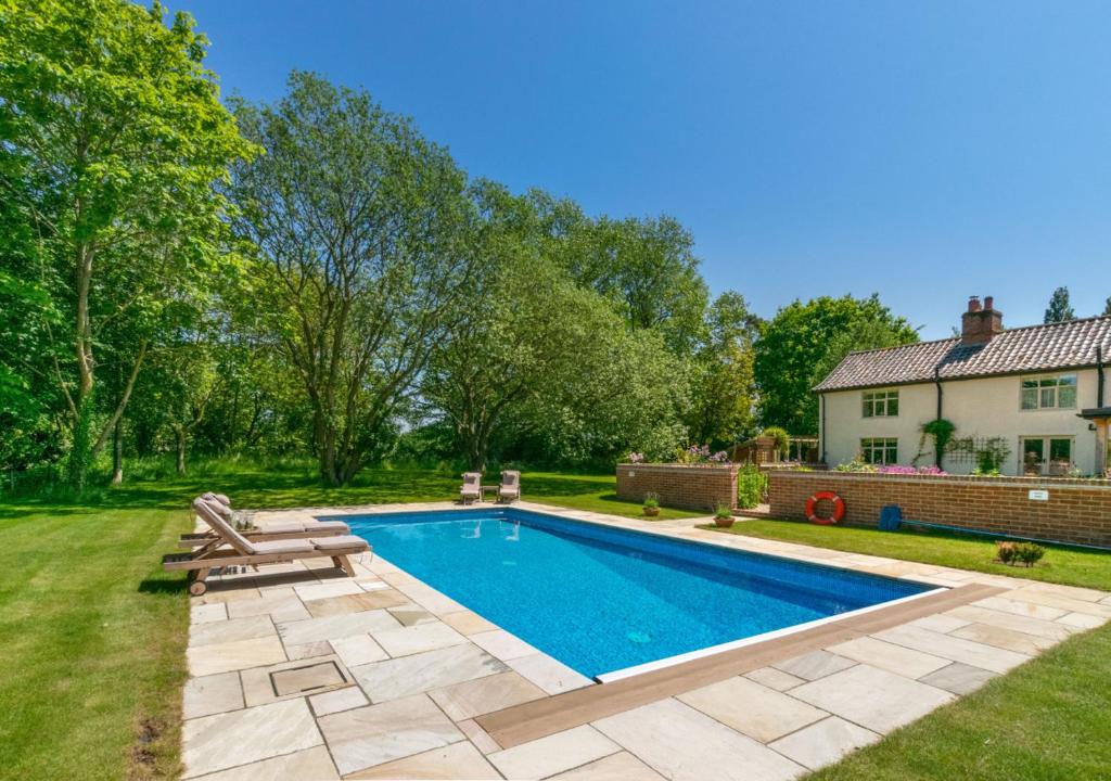 a swimming pool in the yard of a house at Brook Farm Walpole in Walpole